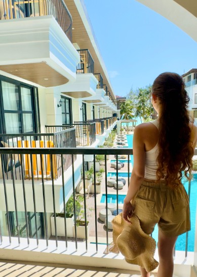 Guest on a balcony overlooking the pool at Ondus Boracay